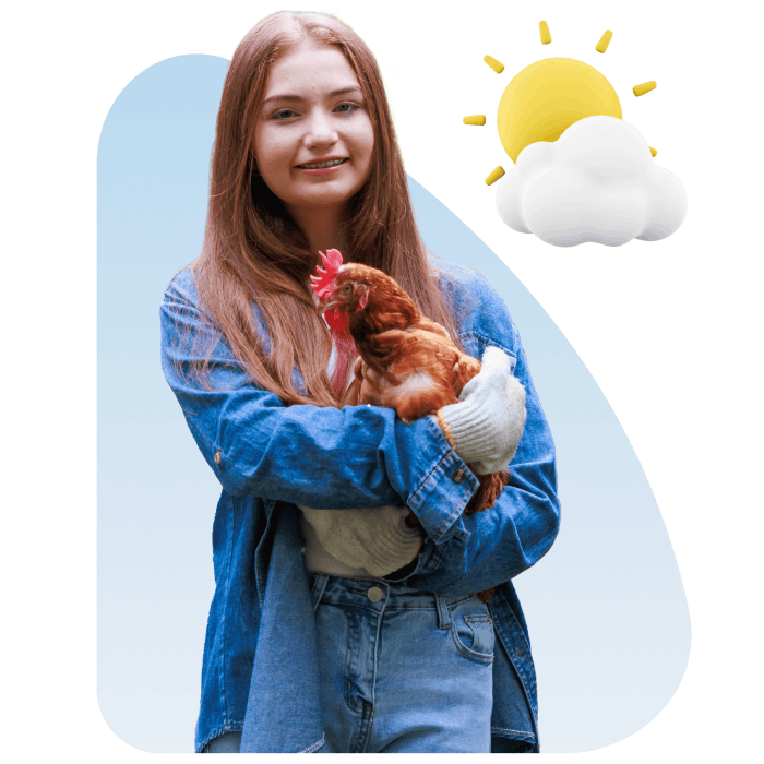 A woman gently cradles a chicken in her arms, showcasing a moment of tenderness and connection with the animal.