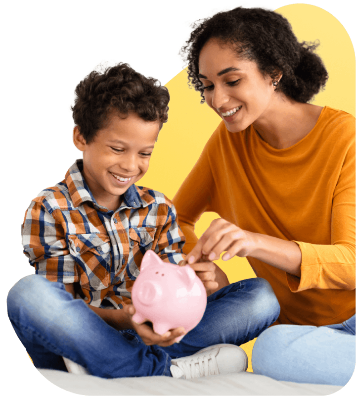 A mother and son joyfully saving coins together, placing them into a colorful piggy bank.