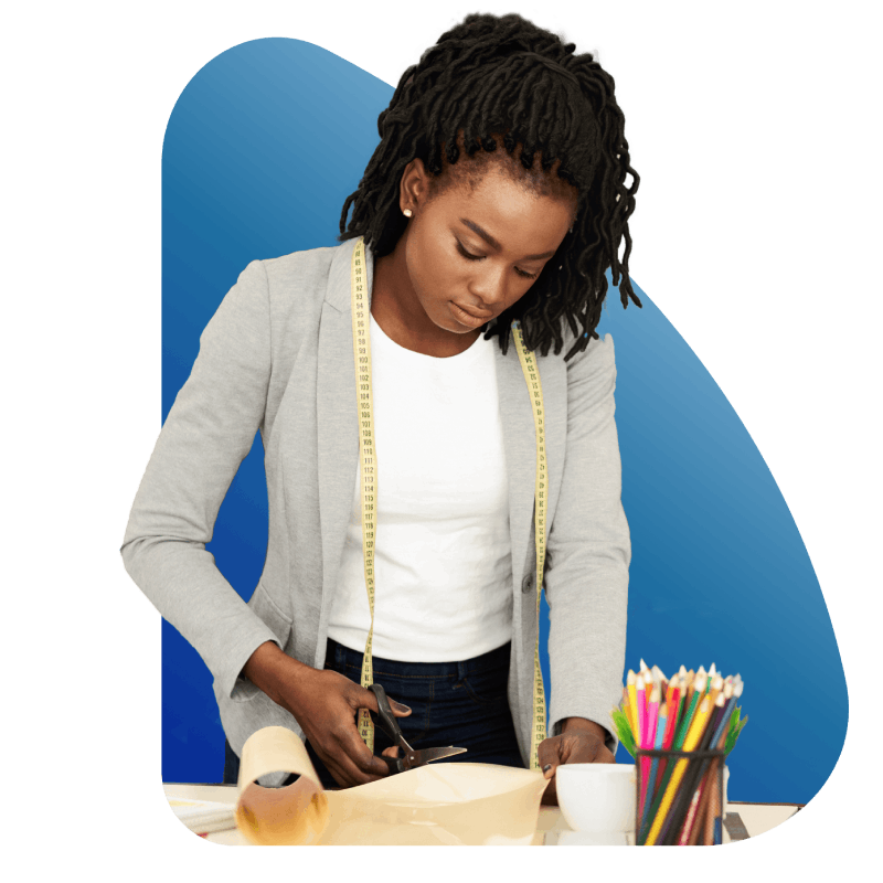 A woman diligently works on a project, using a ruler and pencils to create precise measurements and designs.